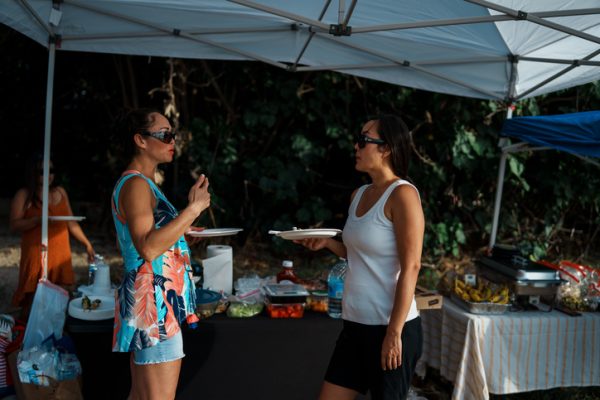 Women talking while at a beach barbecue with friends